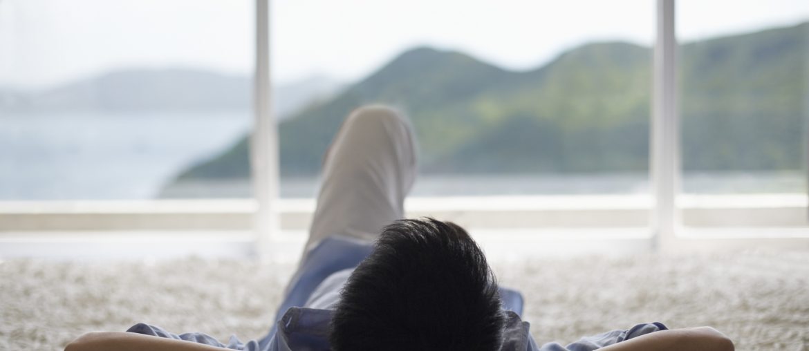 81748821-5 Man Lying Down and Looking Out of Picture Window